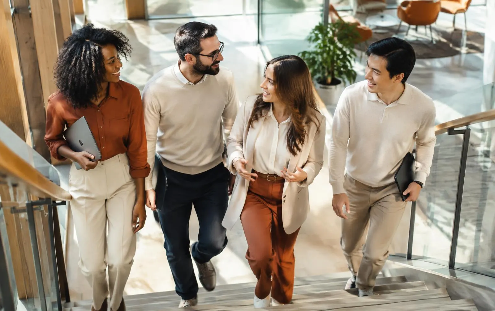 Colleagues walking up the stairs of a bright modern office together